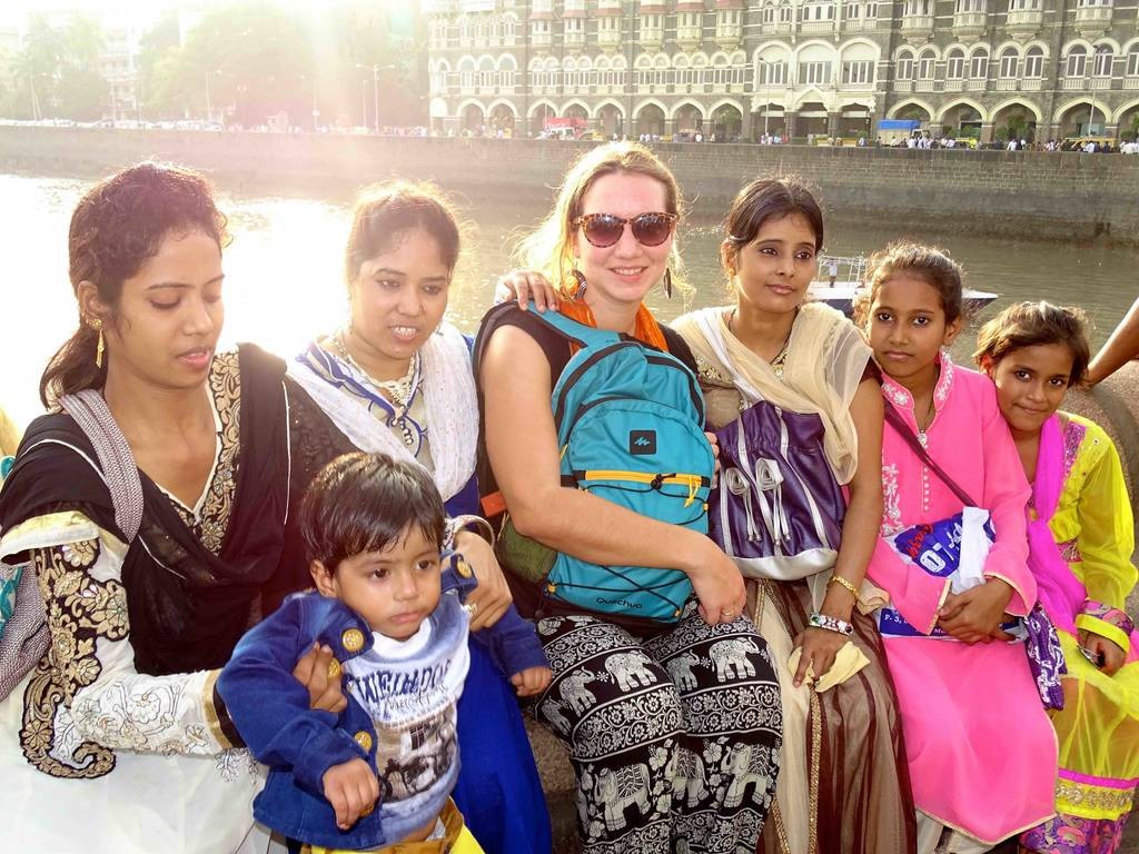 Une touriste et des indiennes devant le taj Mahal hotel a Mumbai en Inde